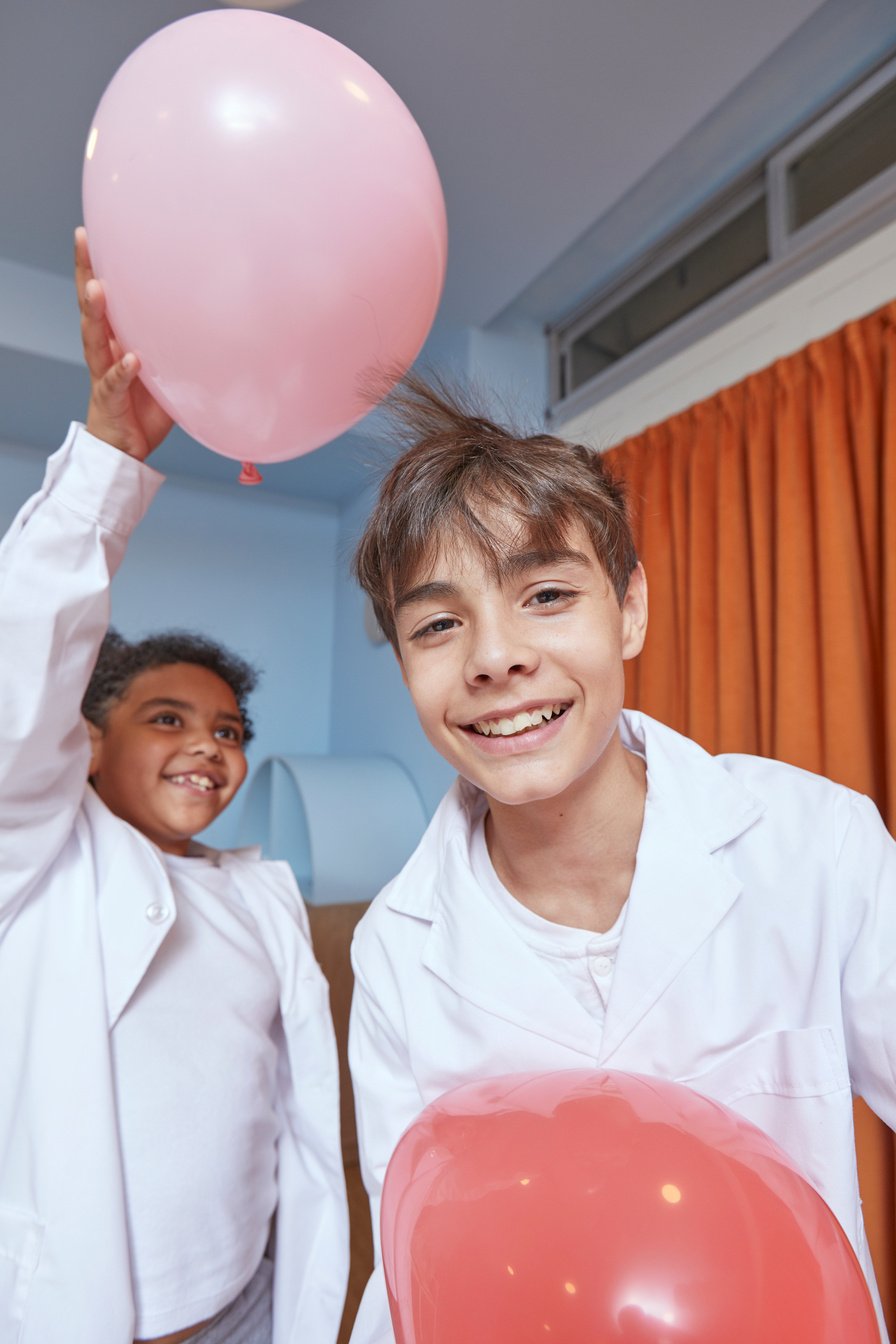 Two Children Doing Science Experiment with Balloons